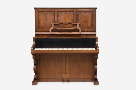 Antique upright piano isolated on white background.の写真素材