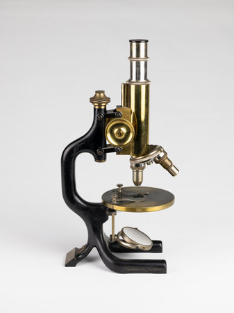 old microscope isolated on white backgroundの写真素材