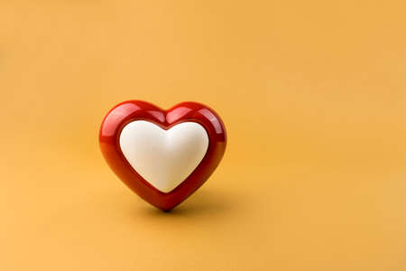 Red heart on yellow backgroundの写真素材