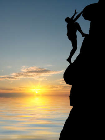 man on top of the mountain reaches for the sunの写真素材