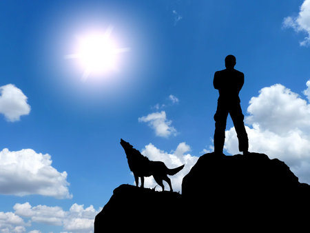 man and a wolf on a mountain topの写真素材