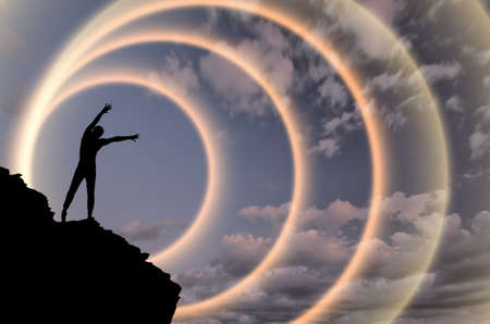 man on top of the mountain reaches for the sunの写真素材