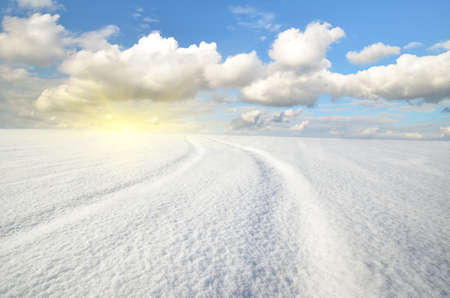 winter landscape against the backdrop of sunny sky with cloudsの写真素材