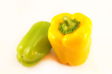 still life of fresh yellow and green peppers on an isolated backgroundの写真素材
