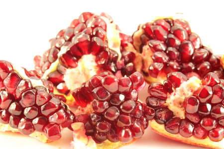 juicy berries sliced pomegranate on a white backgroundの写真素材