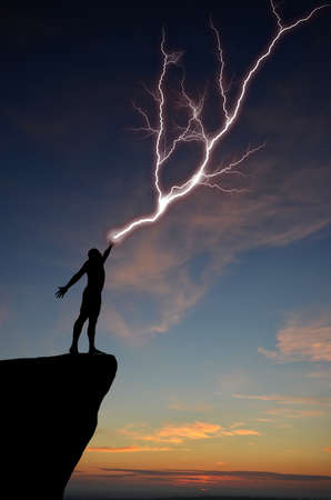 silhouette of a man on a mountain top manufactures of hand zipper. natural compositionの写真素材