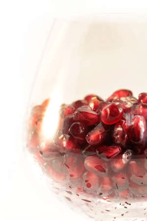 Pomegranate fruit arranged in a glass on a white backgroundの写真素材
