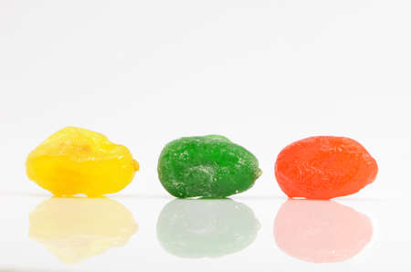 colored sweet fruits on a white backgroundの写真素材