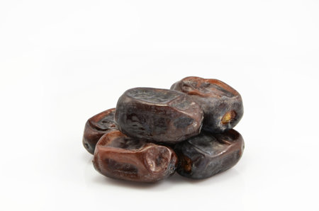 date palm fruits are a bunch on a white background