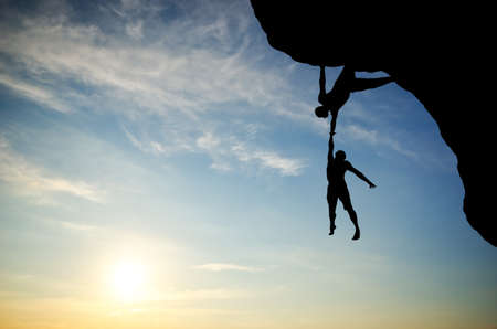 climber on the mountain holding anotherの写真素材