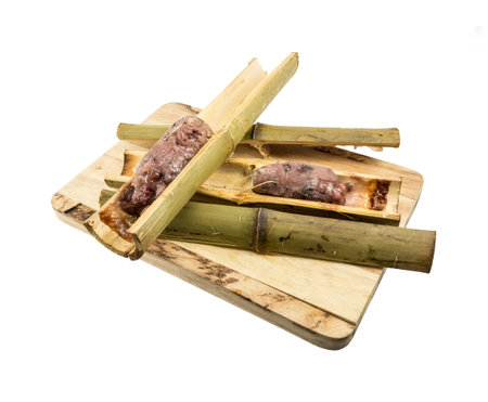 Glutinous rice roasted in bamboo joints Khoalam isolated on white backgroundの写真素材