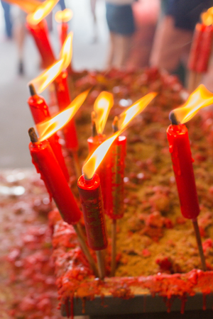 burning red chinese candle in templeの写真素材
