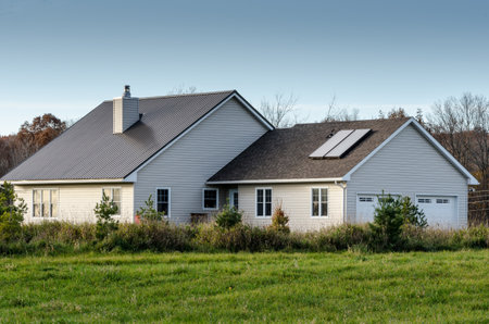 small house with solar panels on roofの写真素材