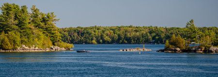 Small fishing boat among the Thousand Islands, with the St. Lawrence River in the foreground