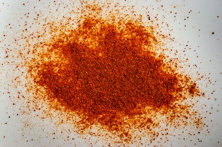mound of chilli pepper spices on a white background