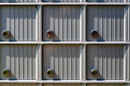 close-up of six locked gray metal mailbox doors