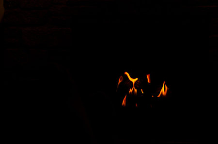 Isolated grouping of orange flames against a black background