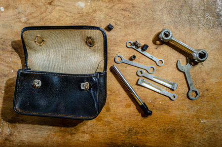 bicycle repair tools and pouch on a wooden workbench