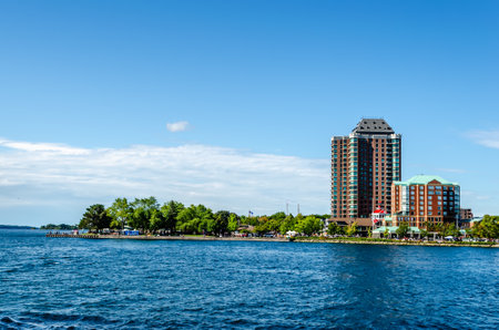 View of a group of waterfront condo buildings on the St. Lawrence River under a blue summer sky.の写真素材