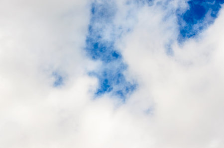 upward view of a dark blue sky covered in wispy white clouds in the daytime