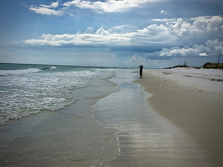 Sandy beach with cloudy skiesの写真素材