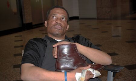 Man shines and proudly display shoeのeditorial素材