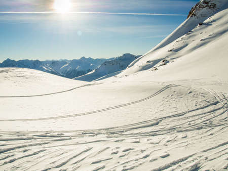 Traces of ski and snowboards in the deep snowの写真素材