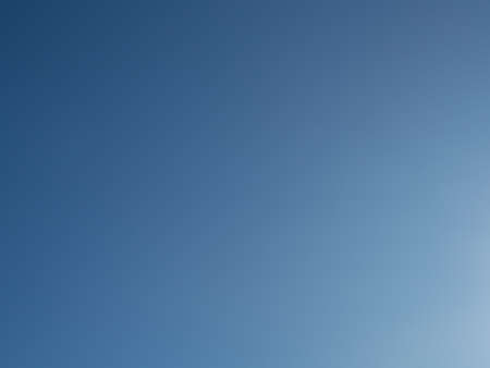 Blue sky, darker on the left side, a natural backgroundの写真素材