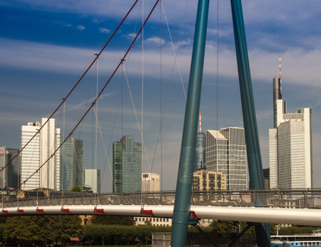 The Holbeinsteg bridge in front of the skyline of Frankfurt, Germanyの写真素材