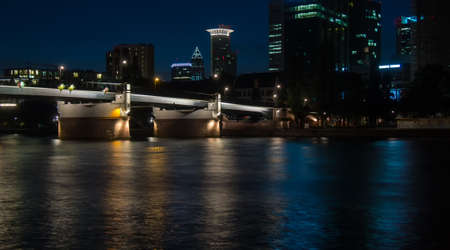 Office buildings and bridge in Frankfurt, Germany, at nightの写真素材