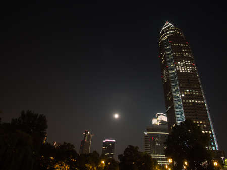 Trade Fair Tower, Messeturm, and full moon in Frankfurt, Germanyの写真素材