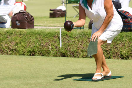 Pensior playing bowls, steadying to rollの写真素材