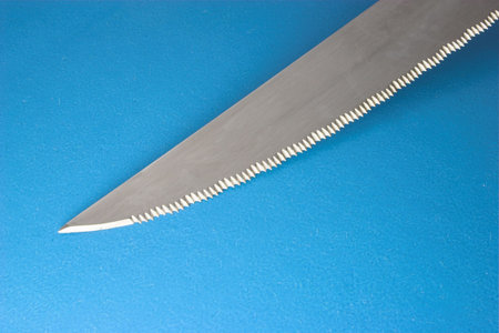 Single steak knifes on blue background