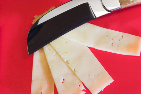Cheese knife with strips of cheese