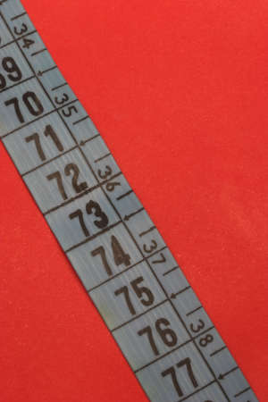 Measure tape with vivd red backgroundの写真素材