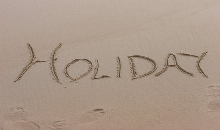 Holiday written on the beach, tempting you to go on a vacationの写真素材