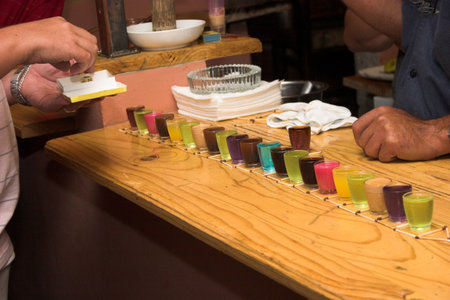 Drinking games in a bar with colourful shootersの写真素材