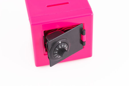 Money safely stored in a pink safeの写真素材