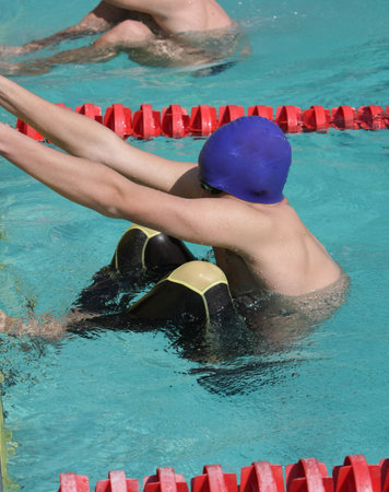 Swimmer at starting block for backstroke event, ready to kick offの写真素材