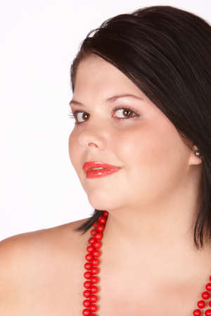Female with bright red shiny lips and beadsの写真素材