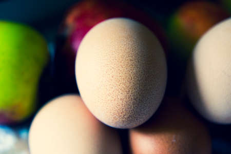 Brown fresh eggs macro shot with apples in back background. Close upの写真素材