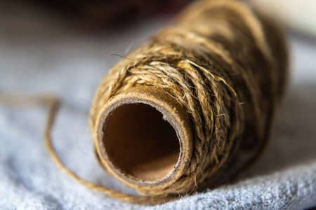Jute string roll close up on linen fabric backgroundの写真素材