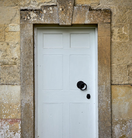Vintage white door in old wall. Close up