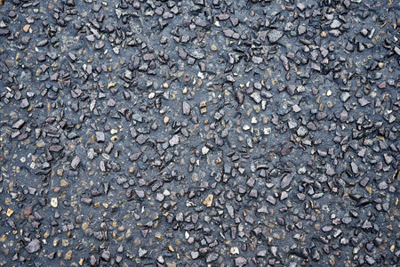Asphalt pavement texture with small rocks. Close up