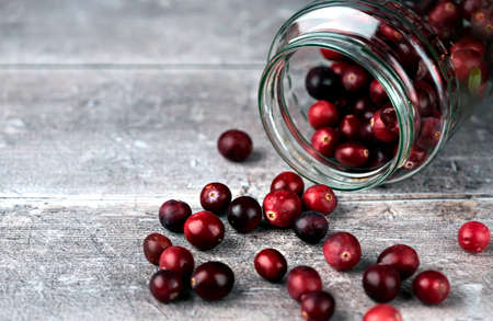 Jar and cranberries. Selective focus on cranberries and jar sides. Close upの写真素材