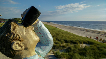 Beach promenade with statue in Wenningstedt on Syltのeditorial素材
