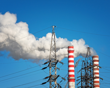 Smoking Pipes of Thermal Power Plant and Tangent Towers as Urban Industrial Sceneの写真素材