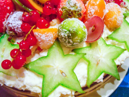 The pie decorated with fresh fruit and berries
