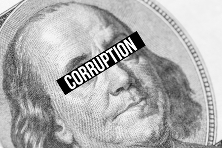 Corruption text on Benjamin Franklin portrait close-up. Concept of corruptionの写真素材