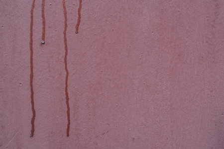 Flowing red paint on the concrete wallの写真素材
